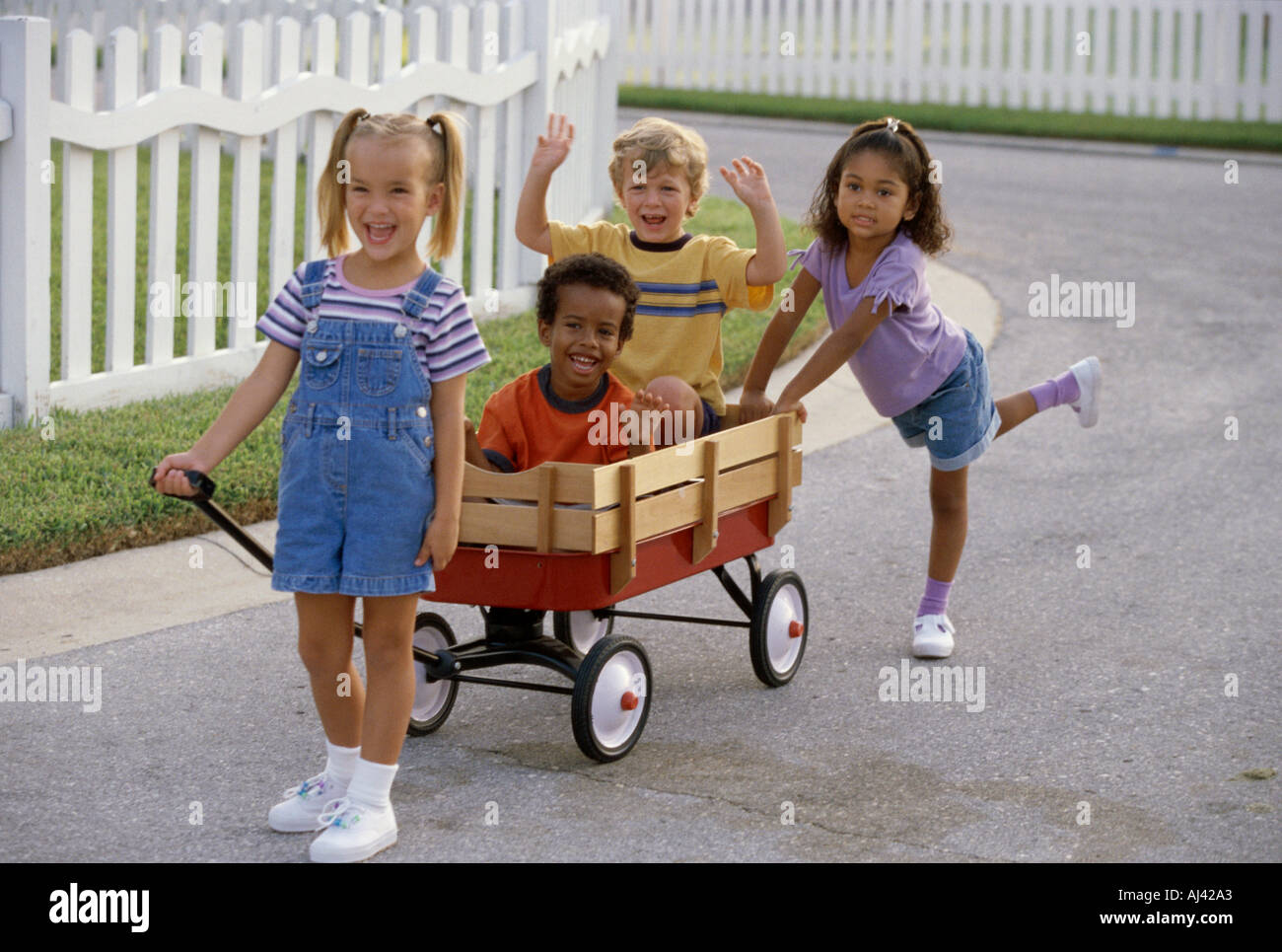 Children pushing pulling wagon hi-res stock photography and images - Alamy