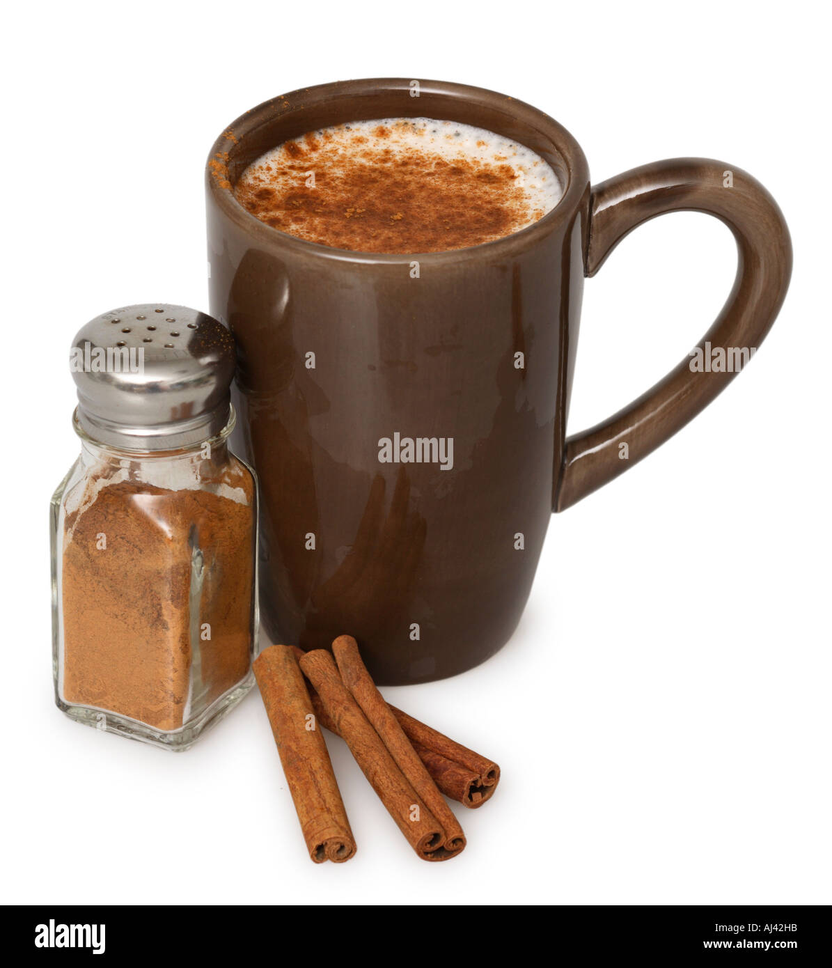 Latte in Coffee Mug, Cinnamon Shaker and Cinnamon Sticks Stock Photo