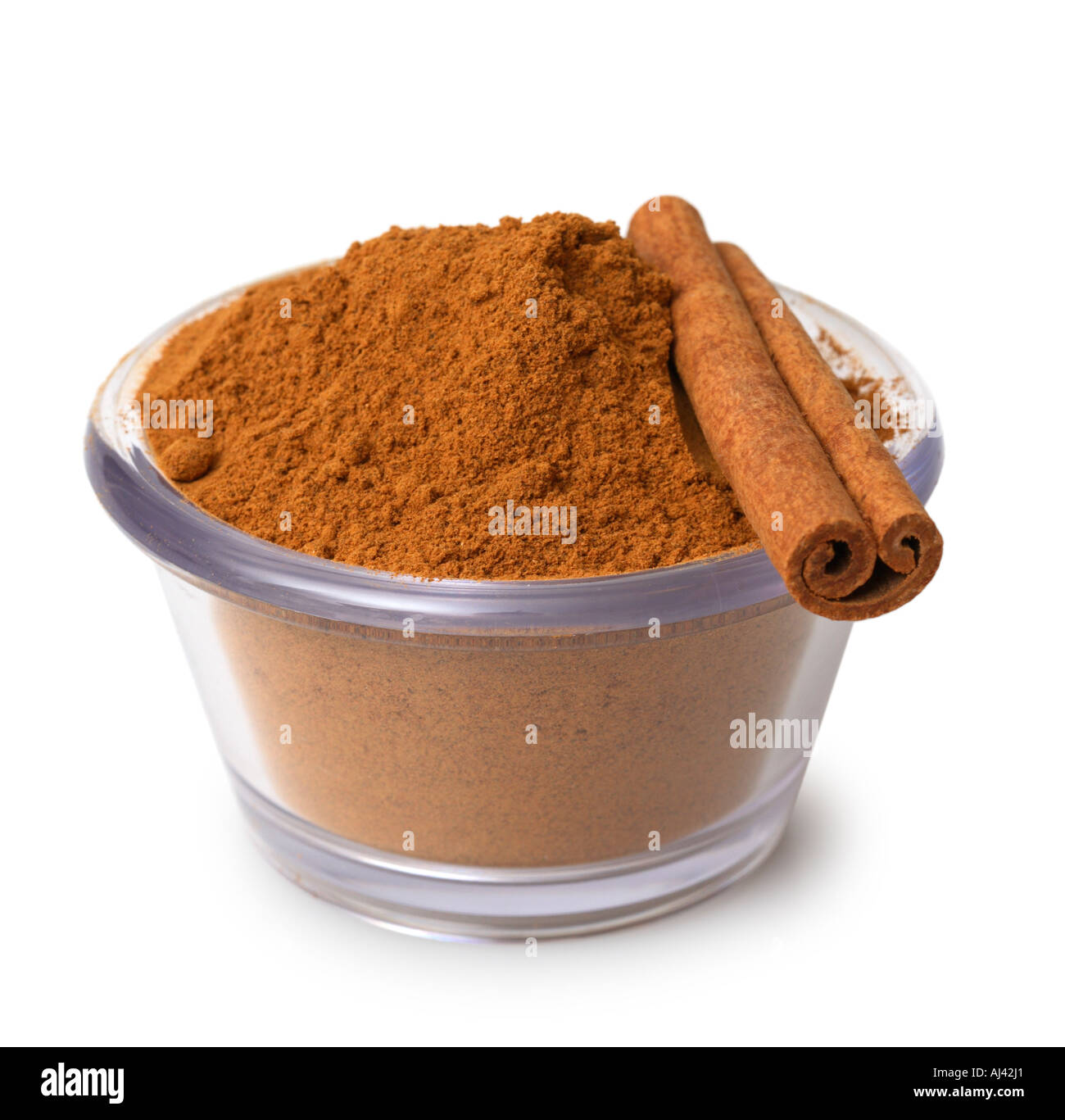 Dish of Ground Cinnamon with Cinnamon Stick Stock Photo