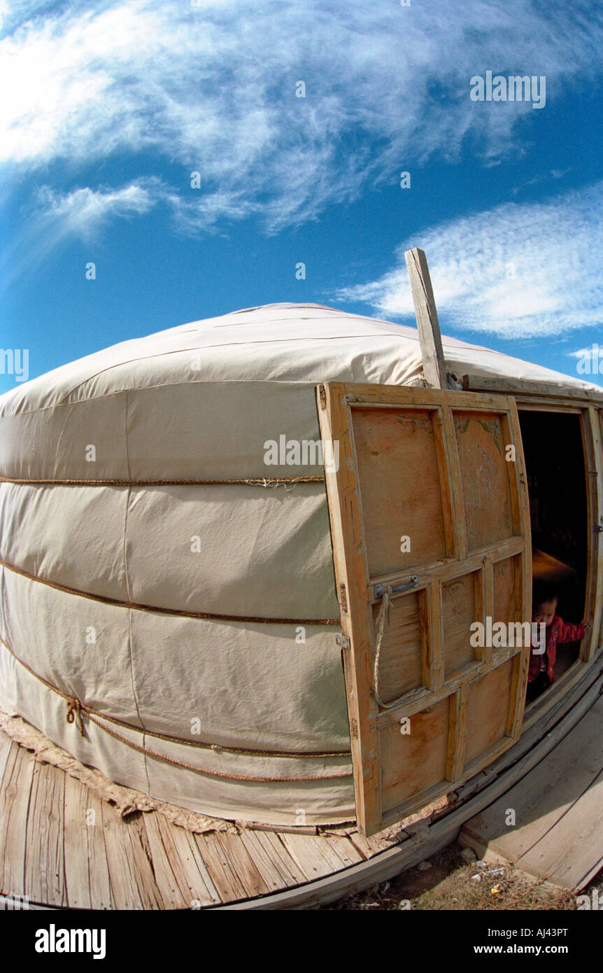 A kid looks out from Mongolian traditional dwelling ger or yurt. Touristic shop. Yolyn am. South Gobi desert. Mongolia Stock Photo