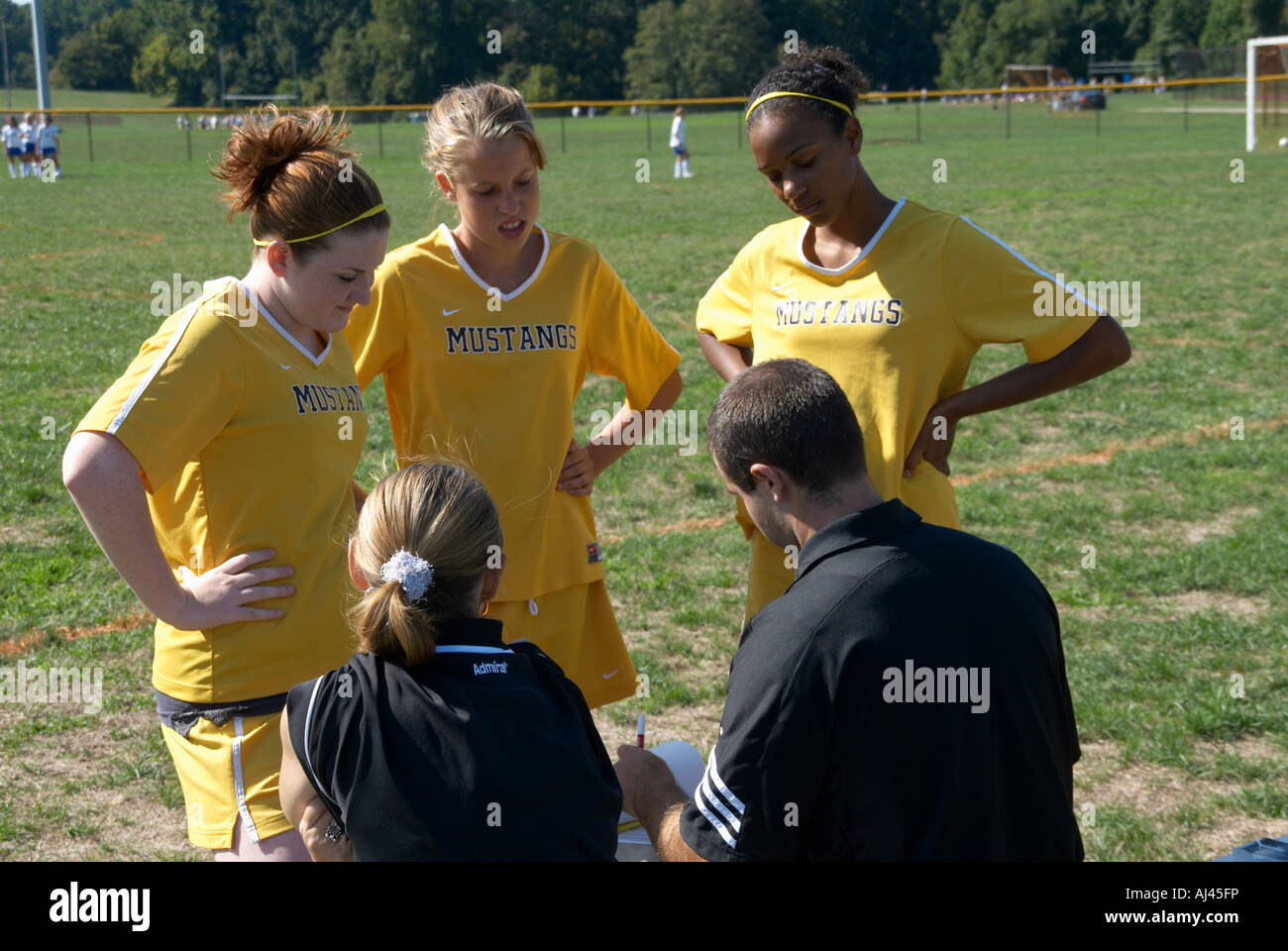 coach talks to high school girls soccer  team before the game Stock Photo