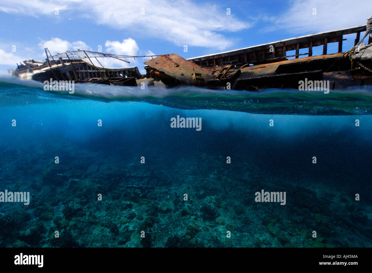 Split image of old fishing boat wreck on shallow reef Ailuk atoll Marshall Islands Pacific Stock Photo