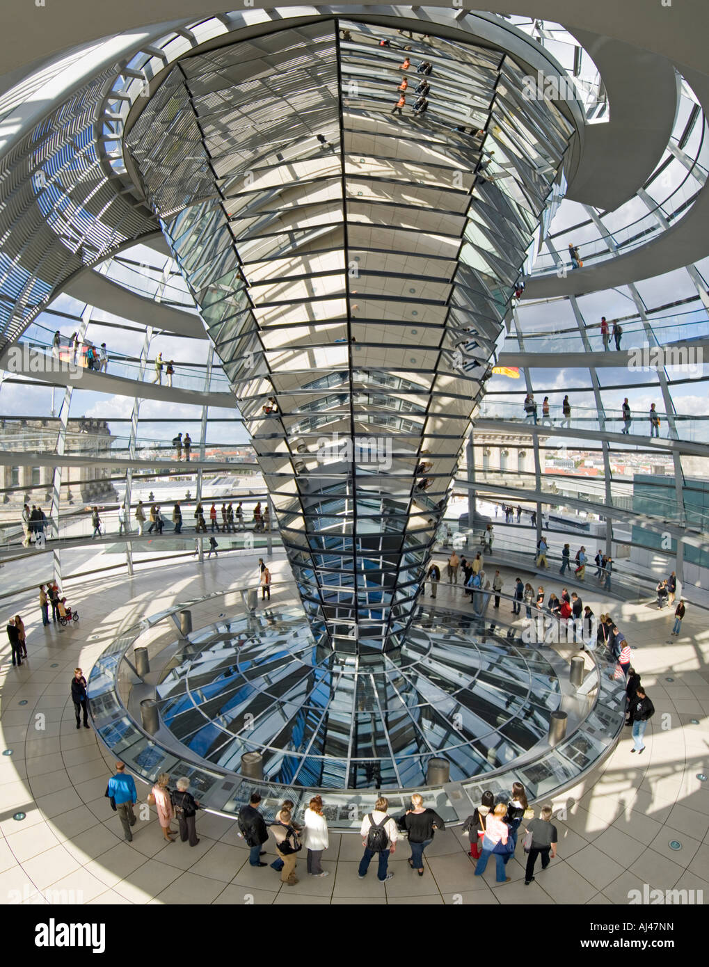 A 3 picture stitch panoramic view of tourists inside the dome on top of the Reichstag - the german parliment building. Stock Photo