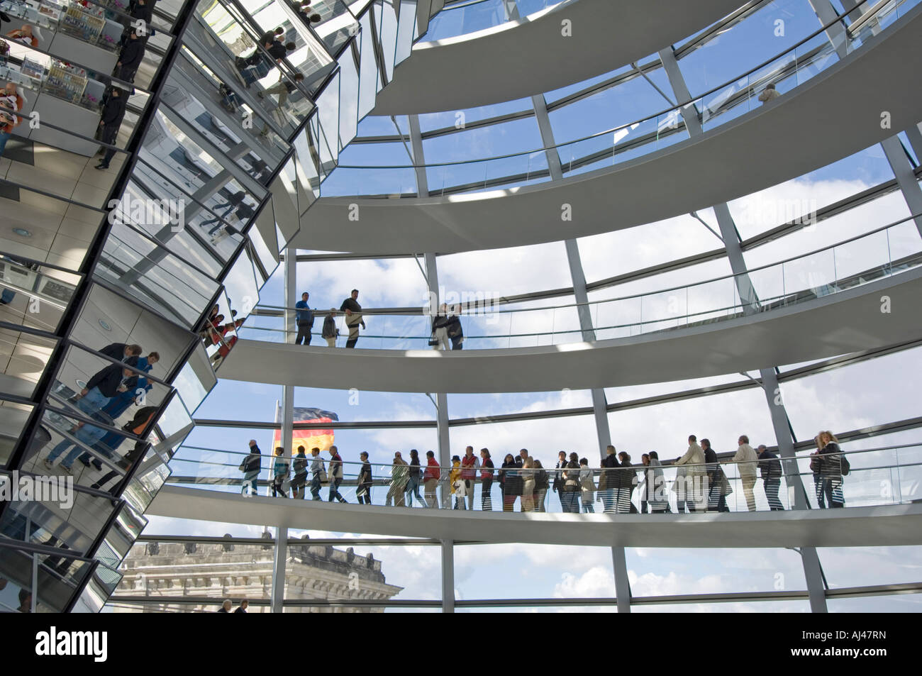 A wide angle view of tourists on the walkway inside the dome on top of the Reichstag - the german parliment building. Stock Photo
