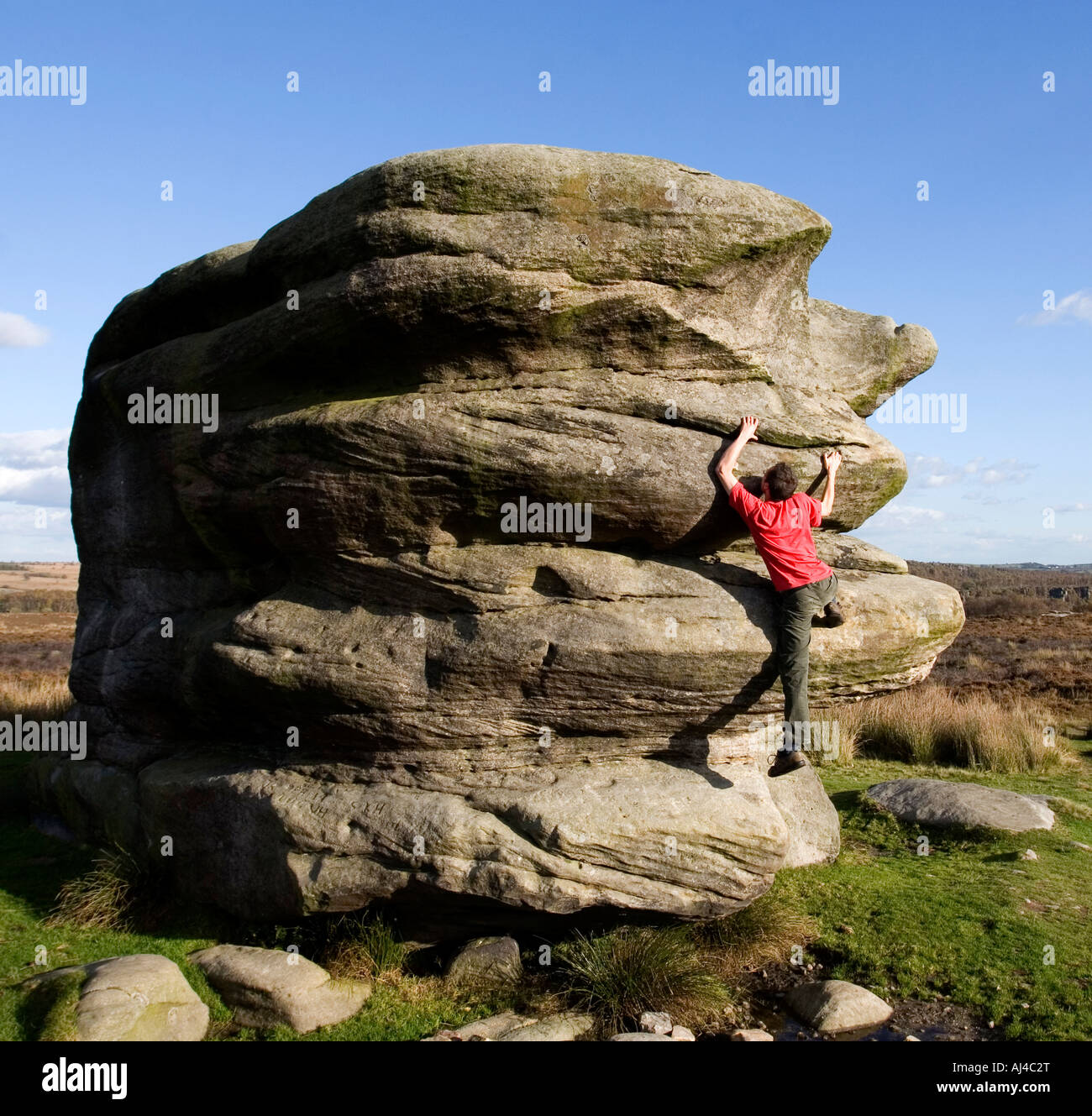 Climbing the Eagle Stone above the village of Baslow Peak District National Park Derbyshire nr Sheffield England Stock Photo