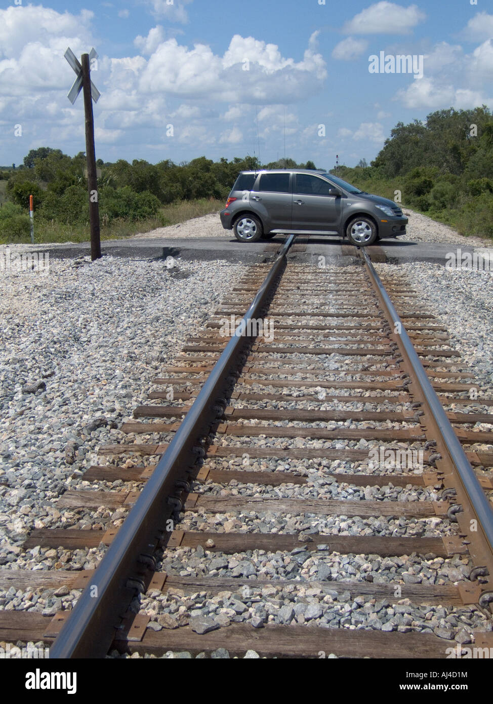 railroad tracks RR Xing car on crossing train rails hazard danger Stock