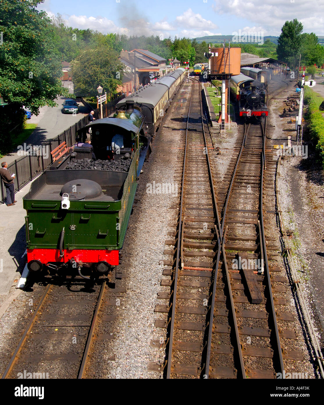 Two steam trains on the track at Buckfastleigh station on the South Devon Railway with clear blue sky Stock Photo