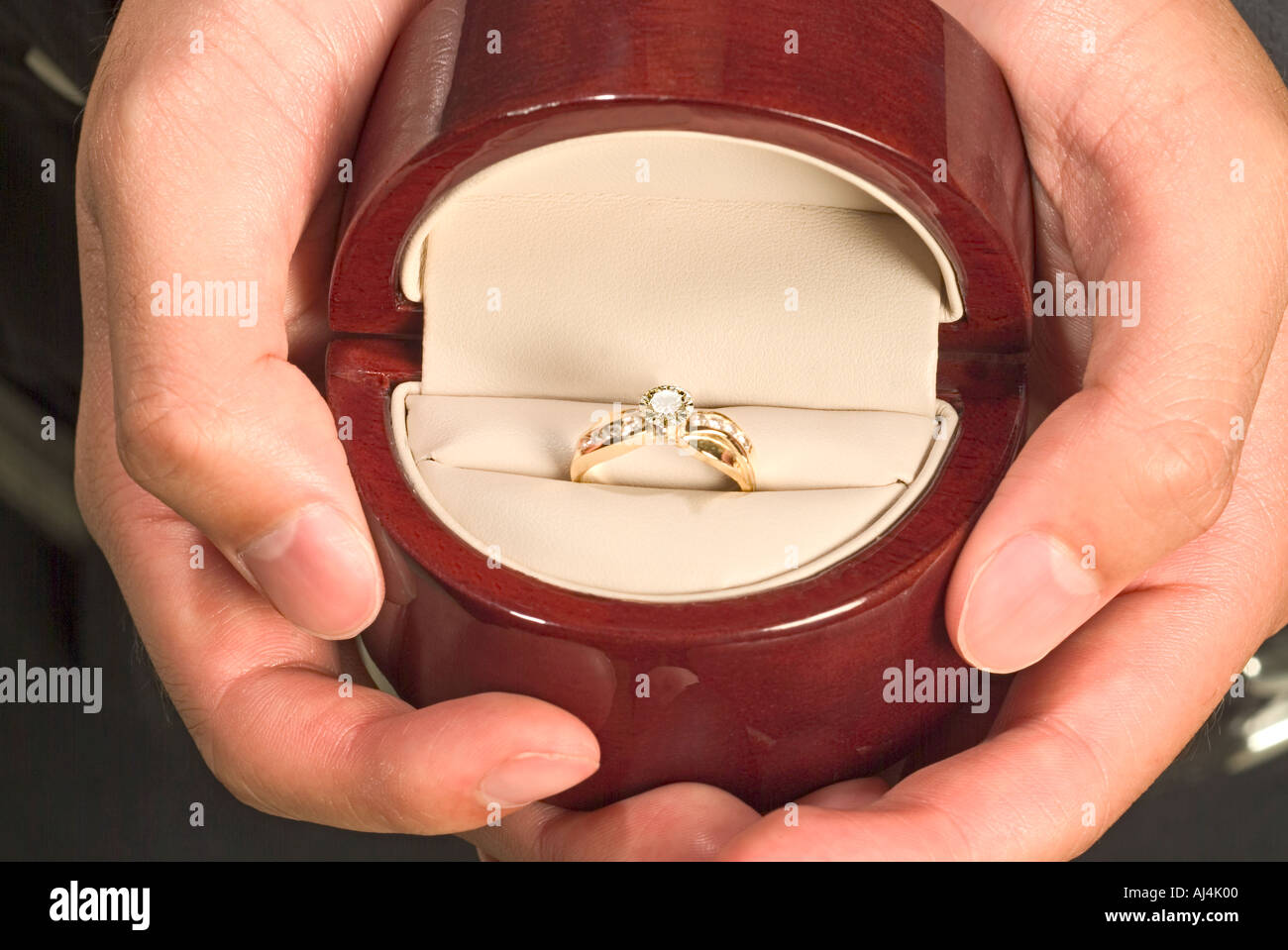 Hands holding diamond ring in box Stock Photo