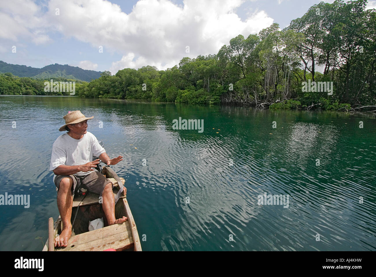 Local man guides native outrigger to edge of mangrove swamp in Kosrae Federated States of Micronesia FSM Stock Photo