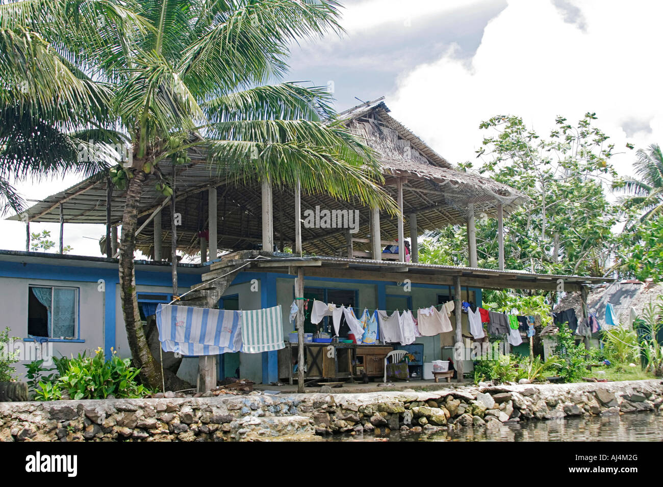 Typical home in the more urban area of Kosrae on Finkos River in Micronesia Stock Photo