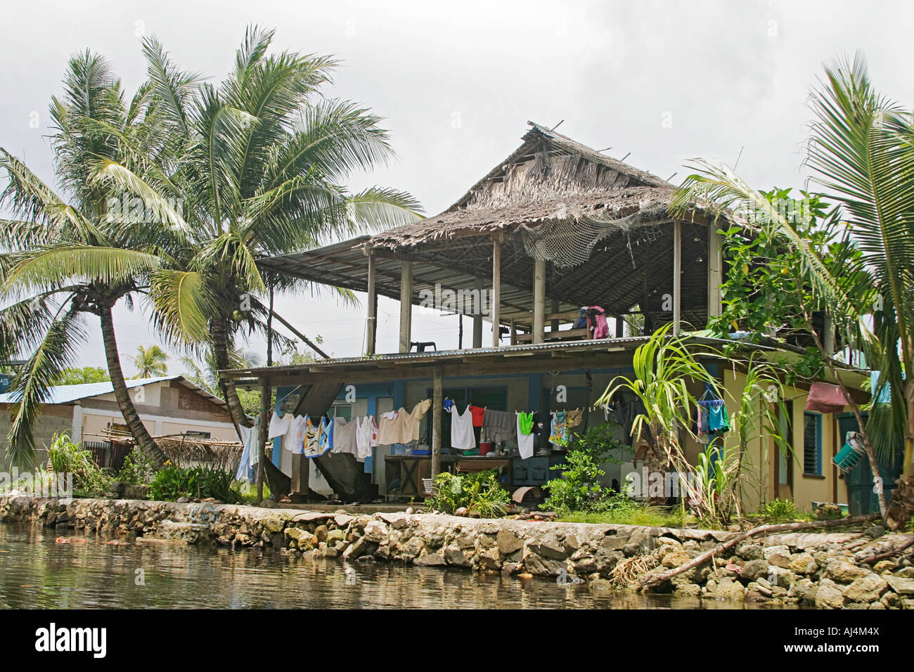 Typical home in the more urban area of Kosrae on Finkos River in Micronesia Stock Photo