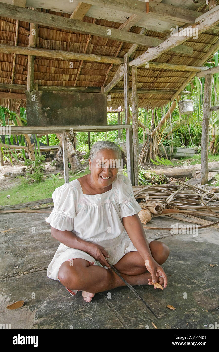 Elderly local woman prepares to make evening meal in her cook hut in an isolated Micronesian village in Kosrae Stock Photo