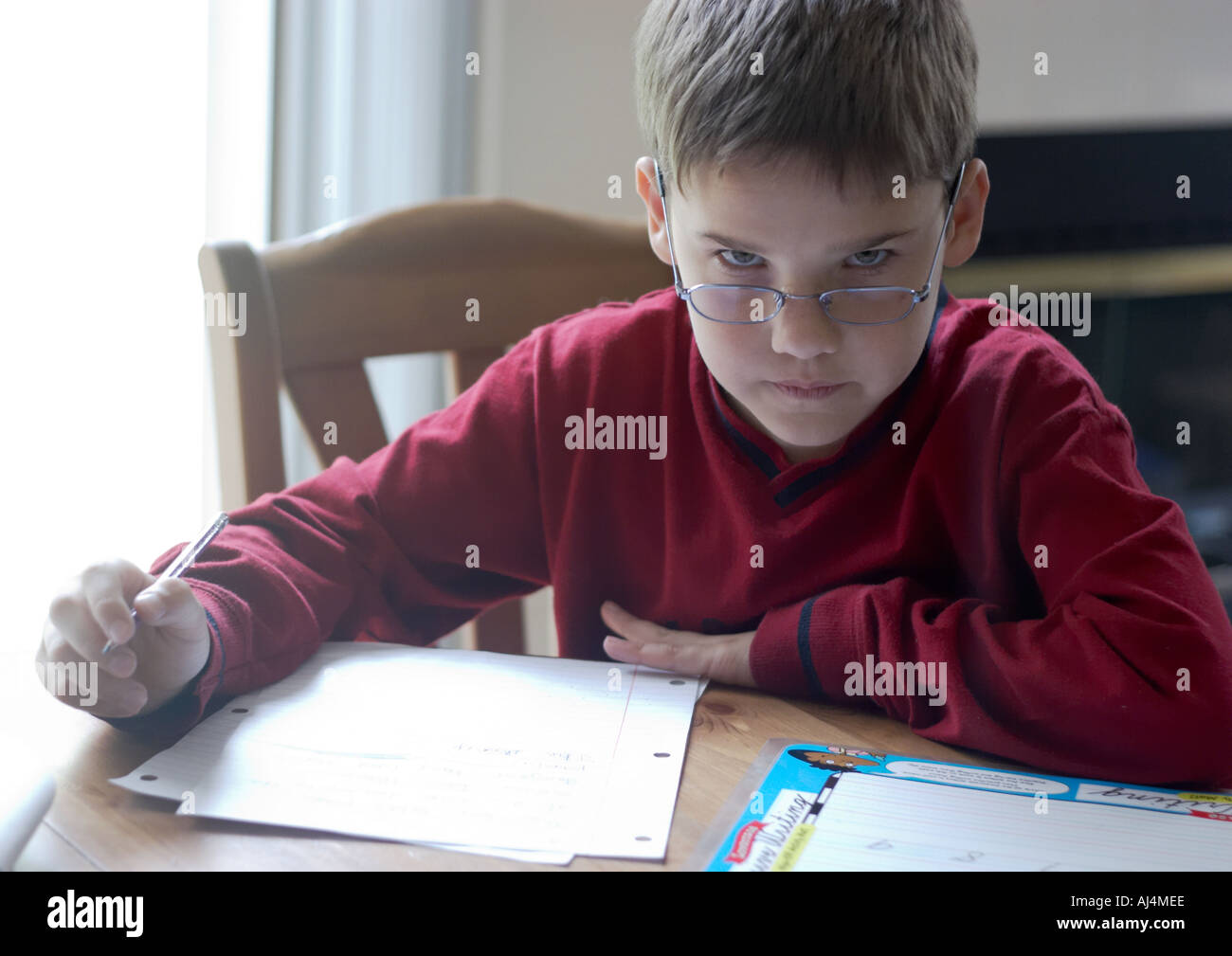 Boy glowers over his glasses Stock Photo