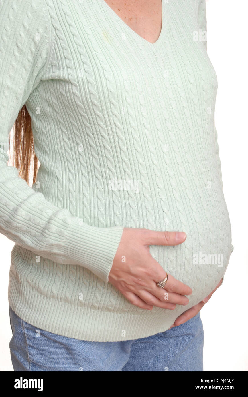 pregnant woman holding her stomach Stock Photo - Alamy