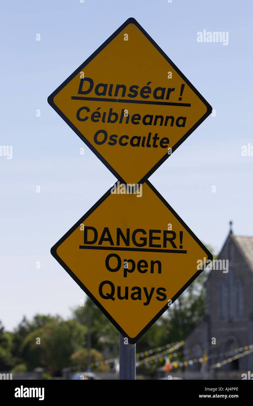 dual language signs for danger open quays signs at harbour Galway city