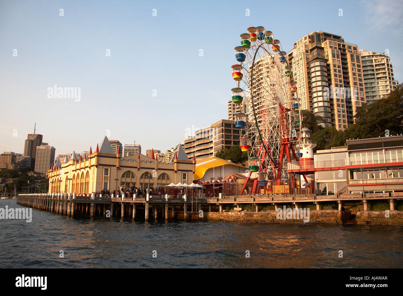 Luna Park funfair on the harbour in warm evening sunlight in north Sydney New South Wales NSW Australia Stock Photo