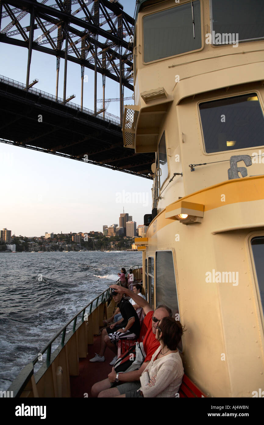 Harbour Bridge beyond ferry in warm evening light Sydney New South Wales NSW Australia Stock Photo