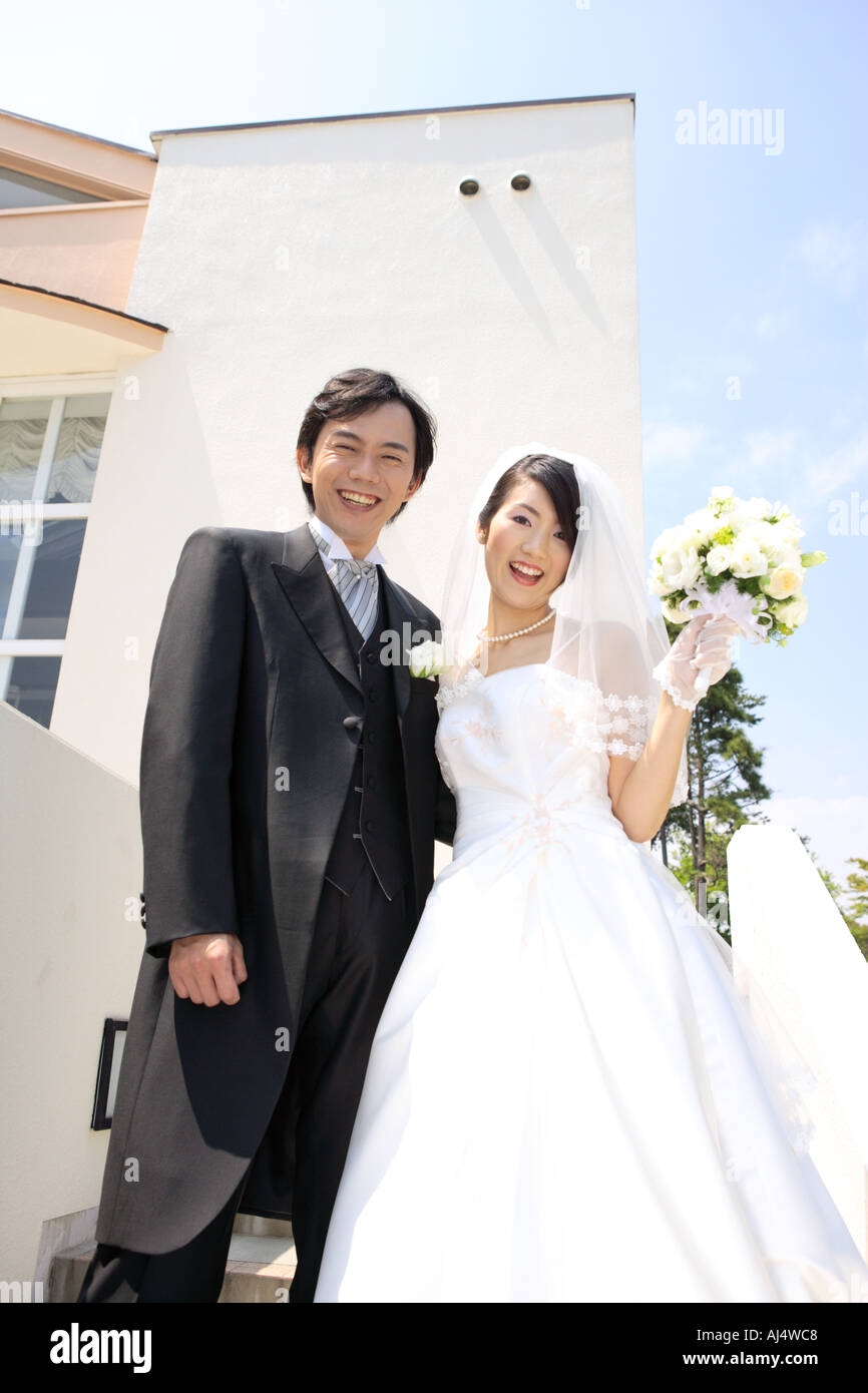 Bride and groom standing Stock Photo - Alamy