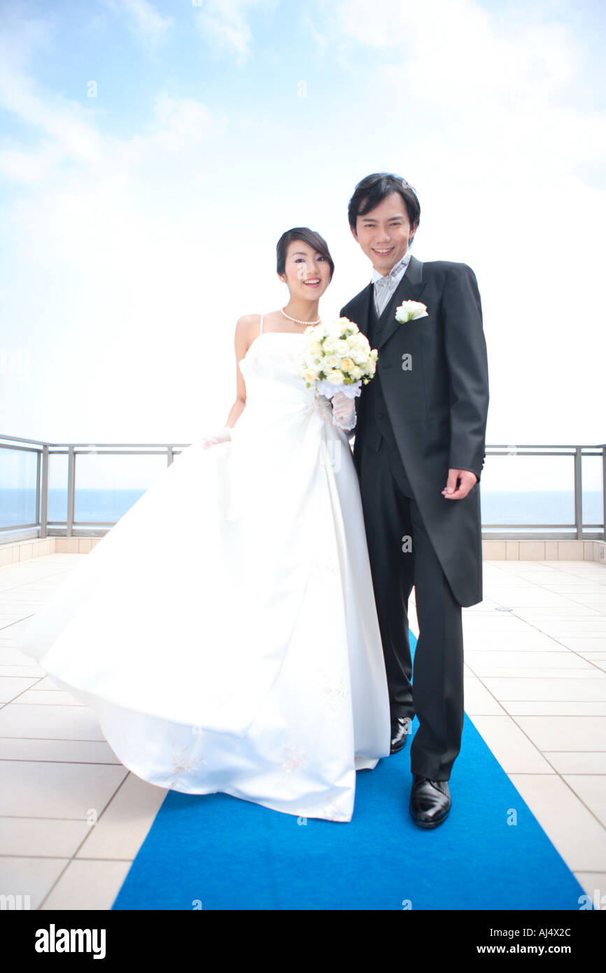 Bride and groom standing and looking at camera Stock Photo - Alamy