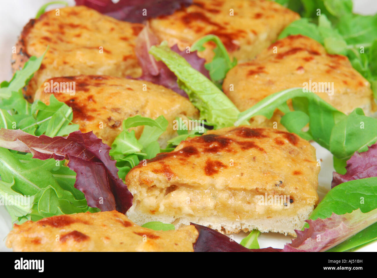 Canapes of Welsh rarebit on toast with salad Stock Photo