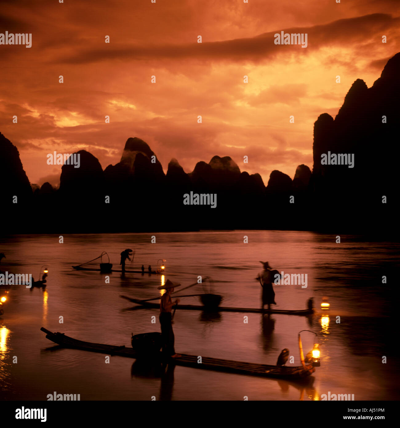 Poetic riverscape with fishermen fishing on Li River at sunset hours, Guilin landscape. Stock Photo