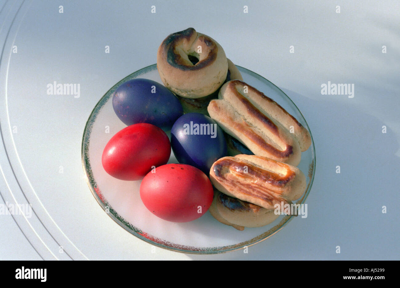 Traditional Greek dyed eggs and almond flavoured sweet biscuits Red dyed eggs are served and eaten on Easter Sunday Stock Photo