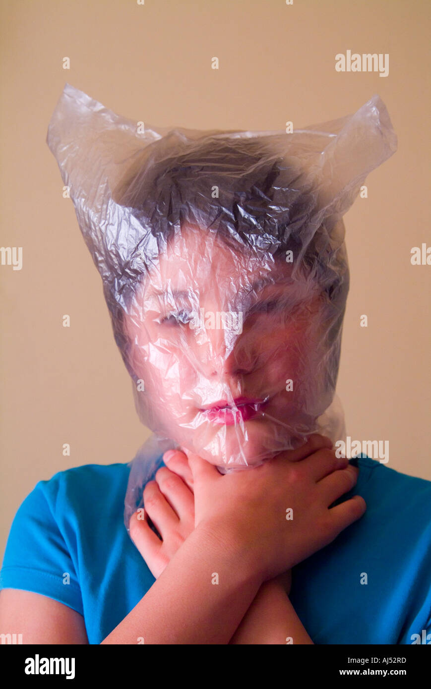 Young girl with head in a plastic bag to illustrate the editorial