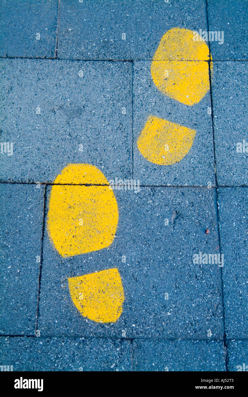 Painted yellow footprints on the sidewalk Stock Photo Alamy