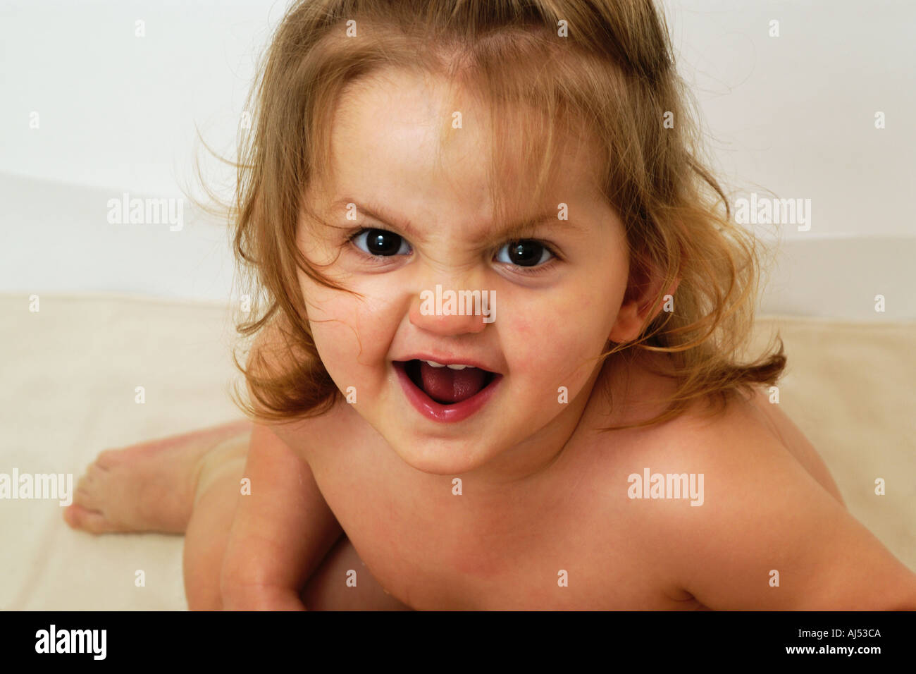 portrait of a young baby looking agressively at camera for joking Stock Photo