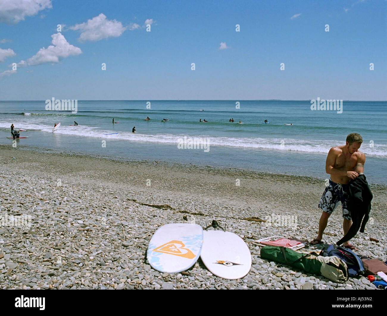 A surfer prepares his wetsuit Stock Photo