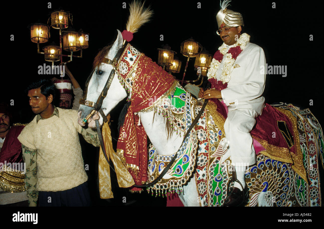 An Indian religious ritual with a middle aged man riding a horse Stock Photo