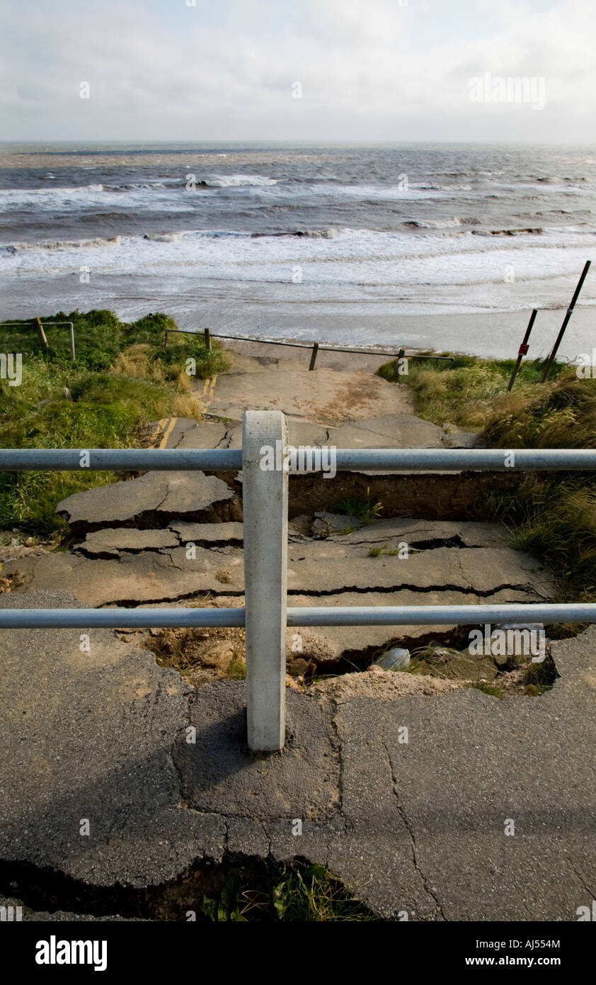Seaside Road barrier and warning signs in Aldbrough, Yorkshire, UK. Erosion along the North Sea coastline. Stock Photo