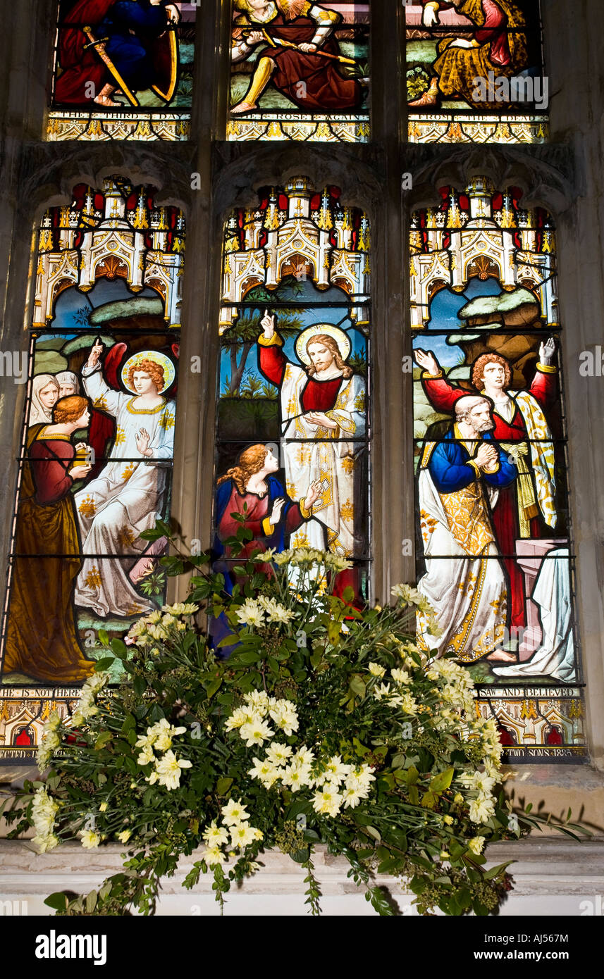 Festival of Flowers and Floral carpets. Stained glass and floral display at Holy Trinity Church, Long Melford, Suffolk. Stock Photo