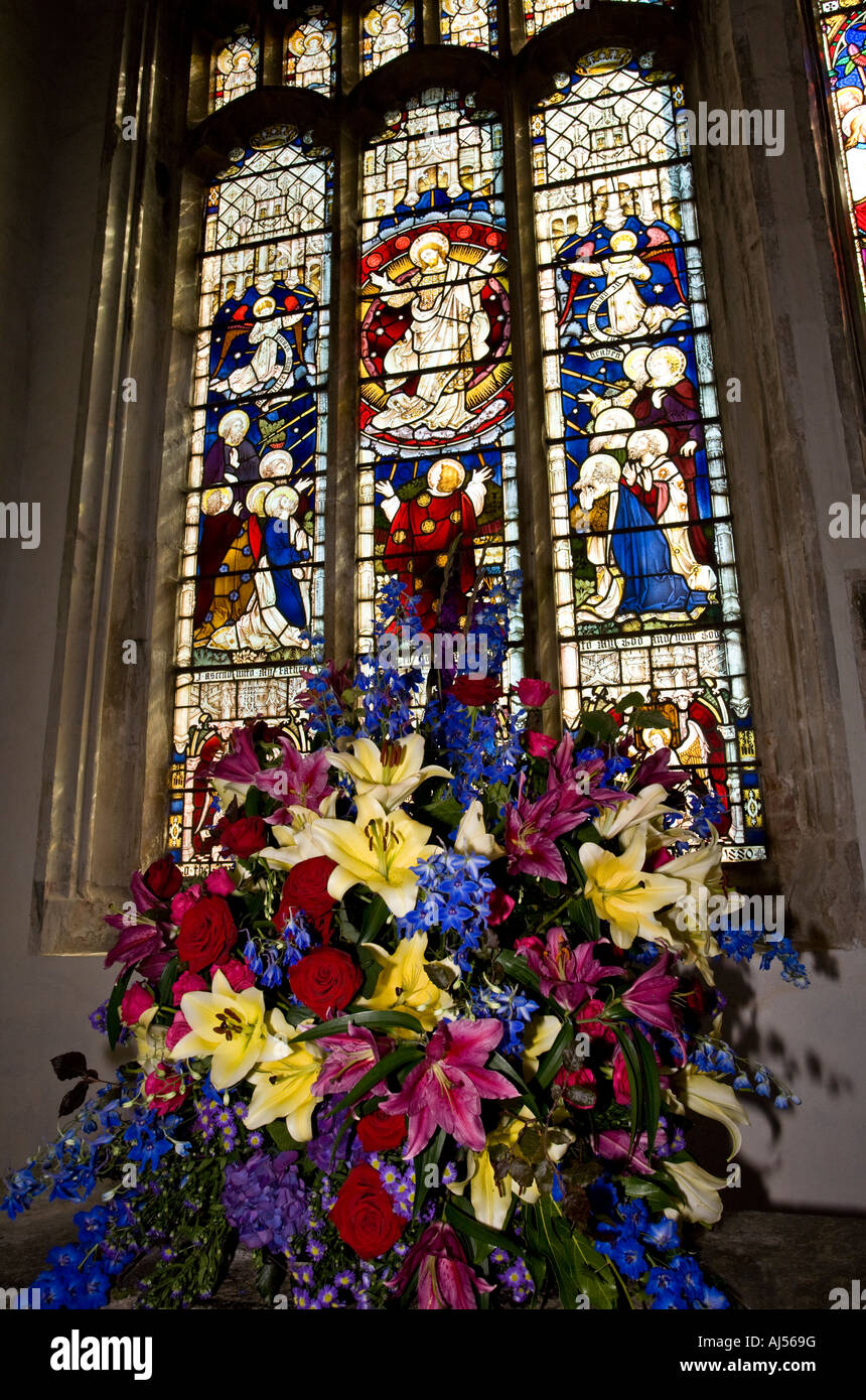 Festival of Flowers and Floral carpets. Stained glass and floral display at Holy Trinity Church, Long Melford, Suffolk. Stock Photo