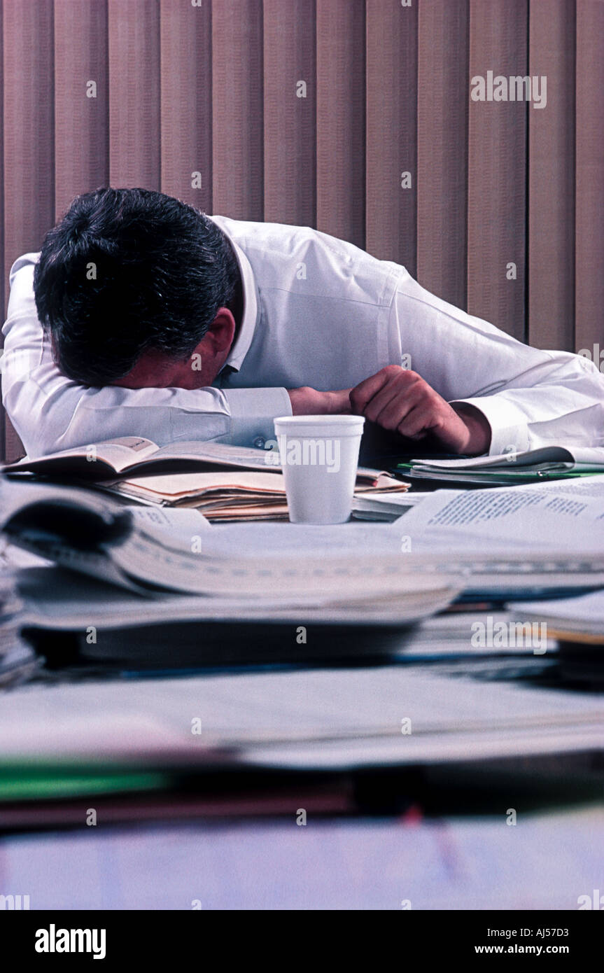 Sleeping at working desk hi-res stock photography and images - Alamy