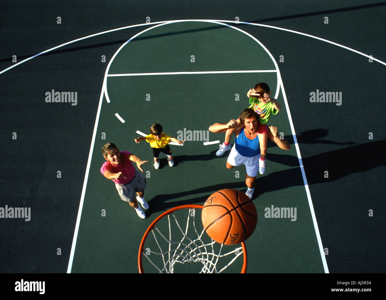 Graphic Family playing basketball together Stock Photo - Alamy