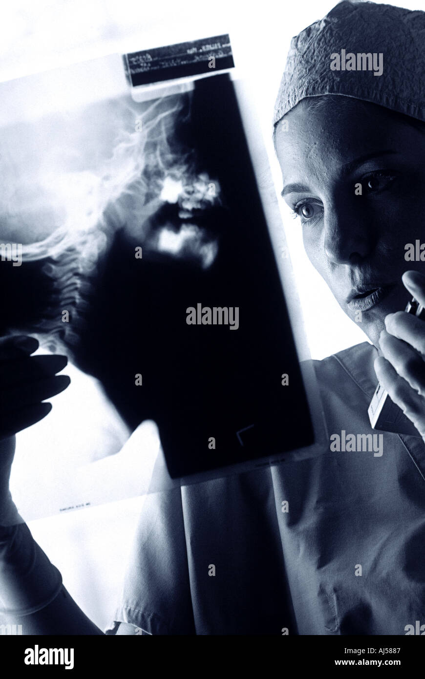 Black and white female surgeon examining X ray before surgery Stock