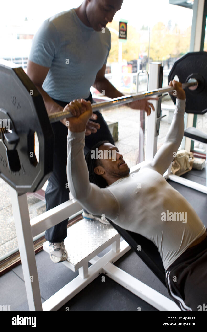 two 2 fit fitness males men exercising in a gym chest bench press workout  Stock Photo - Alamy