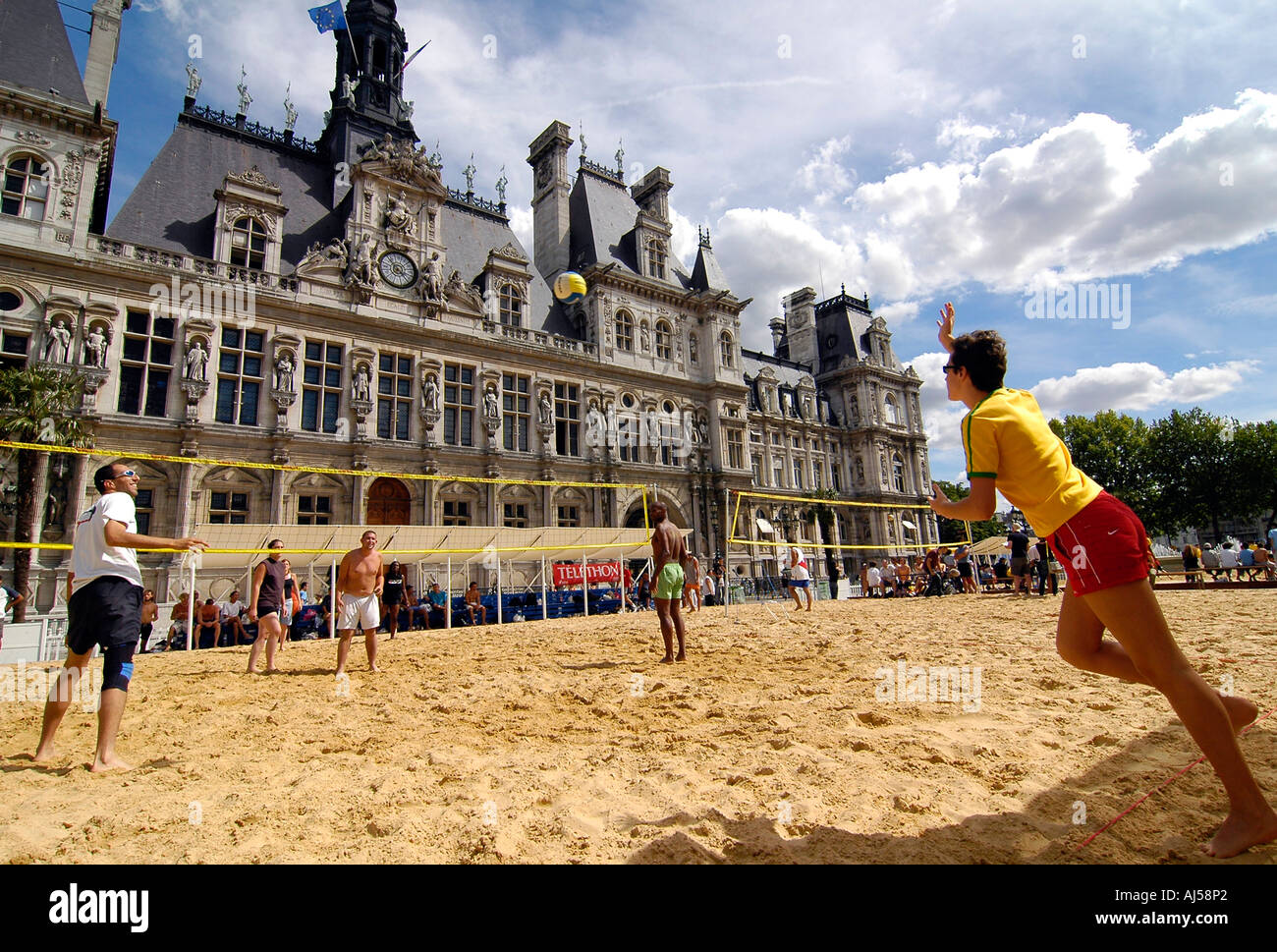 People playing beach volleyball on an artificial field set up in front of City Hall during the Paris Plage event, Paris, France. Stock Photo