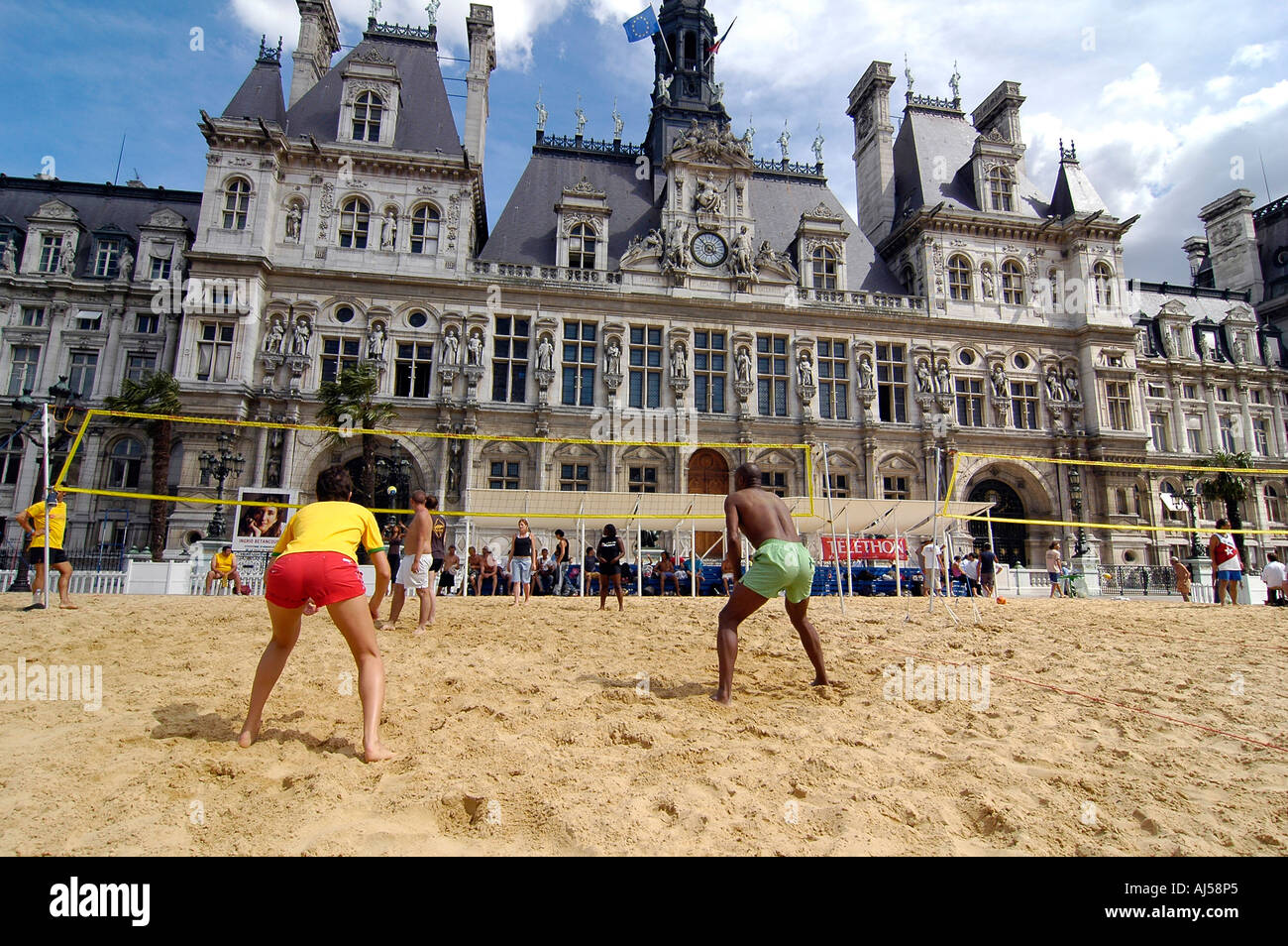 People playing beach volleyball on an artificial field set up in front of City Hall during the Paris Plage event, Paris, France. Stock Photo
