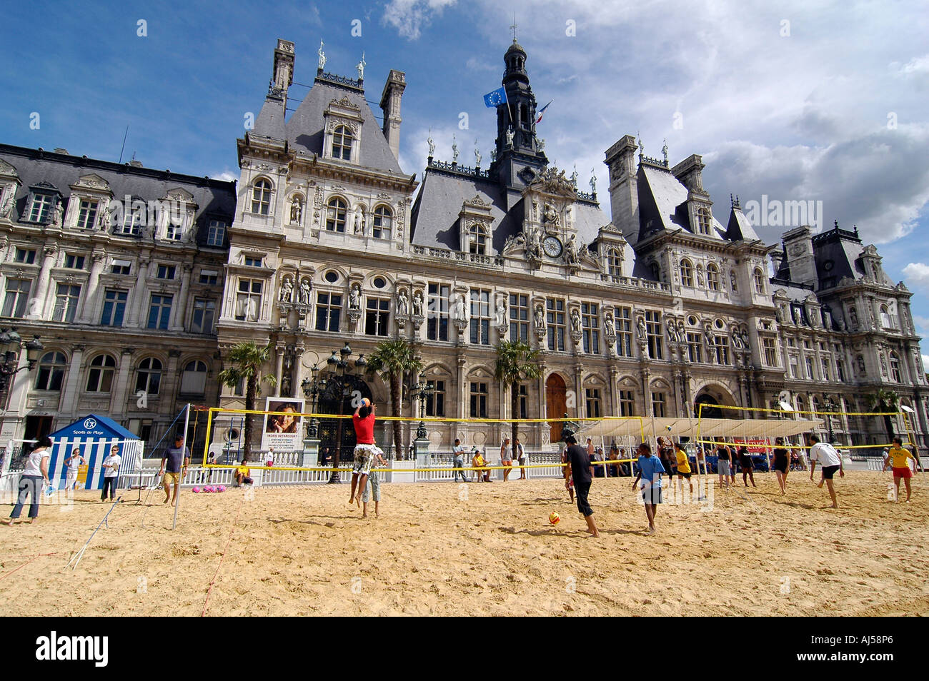 People playing beach volleyball on an artificial field set up in front of City Hall during the Paris Plage event, Paris, France. Stock Photo