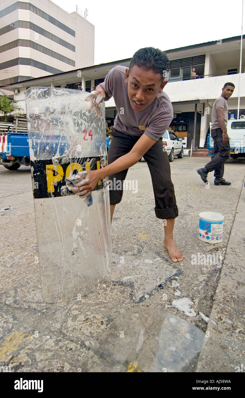 Indonesian police officers washing their anti-riot shields at their central compound in Jayapura, West Papua, Indonesia. Stock Photo