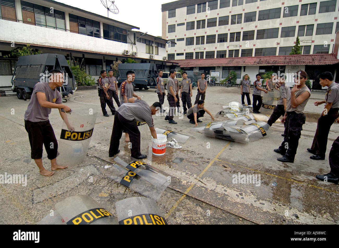 Indonesian police officers washing their anti-riot shields at their central compound in Jayapura, West Papua, Indonesia. Stock Photo