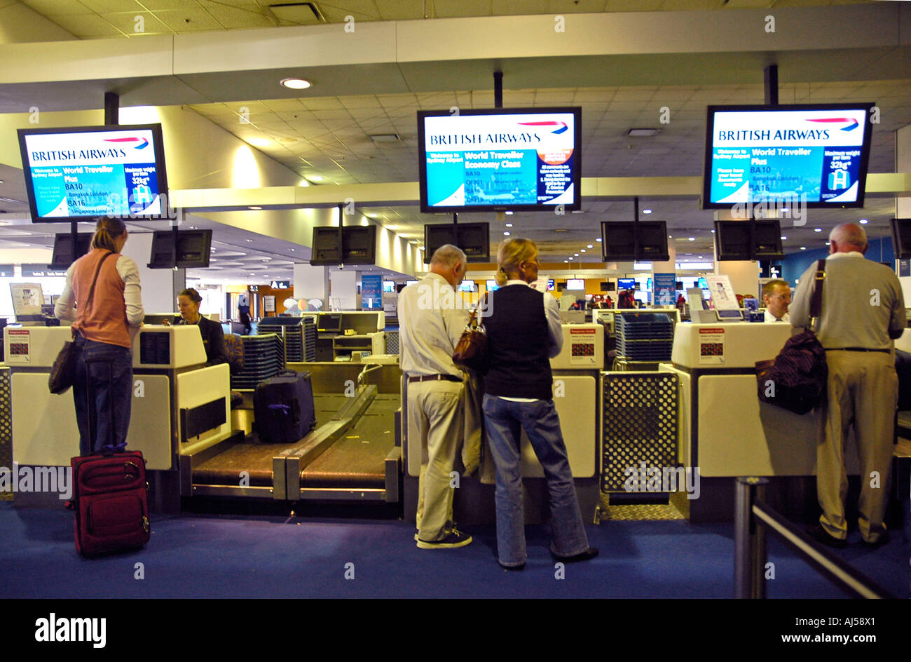 People waiting to register their luggages and get their boarding card at the check-in counter of the Sydney airport, Australia. Stock Photo