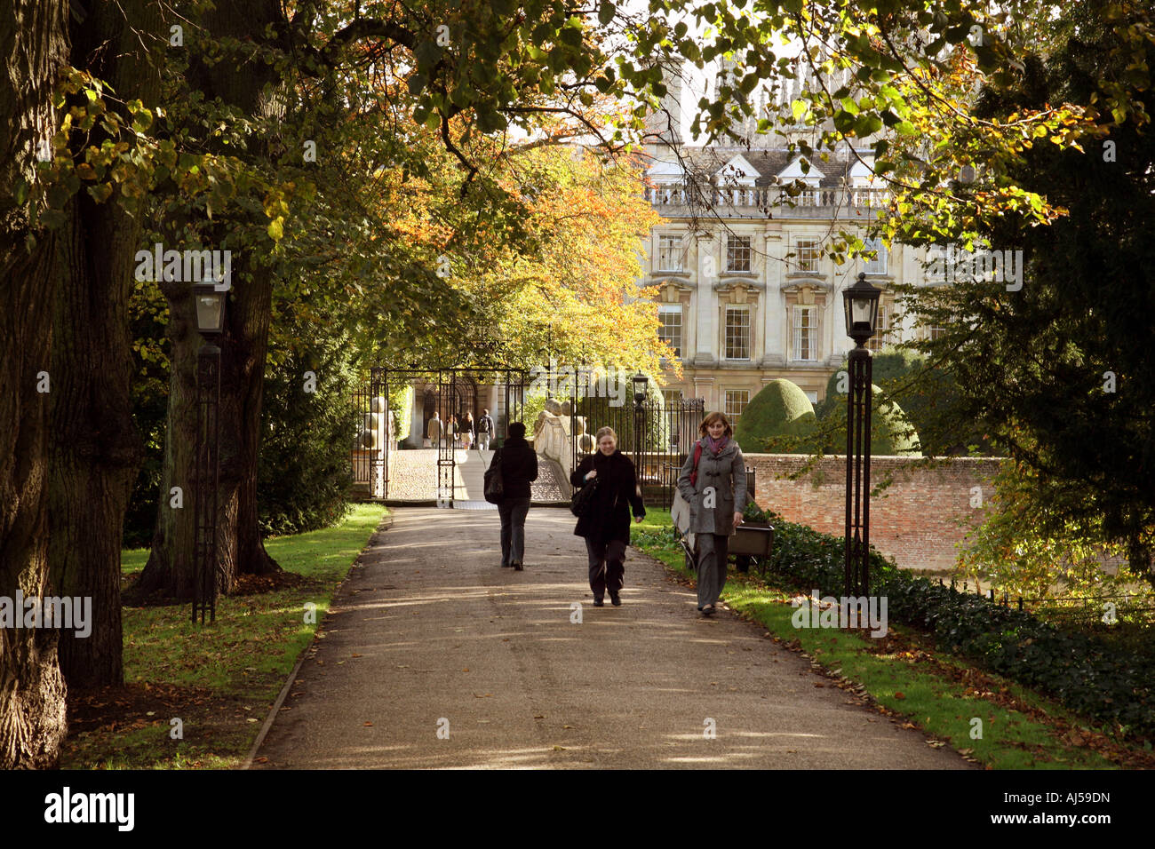Students walking through Clare College in autumn, Clare College, Cambridge University UK Stock Photo