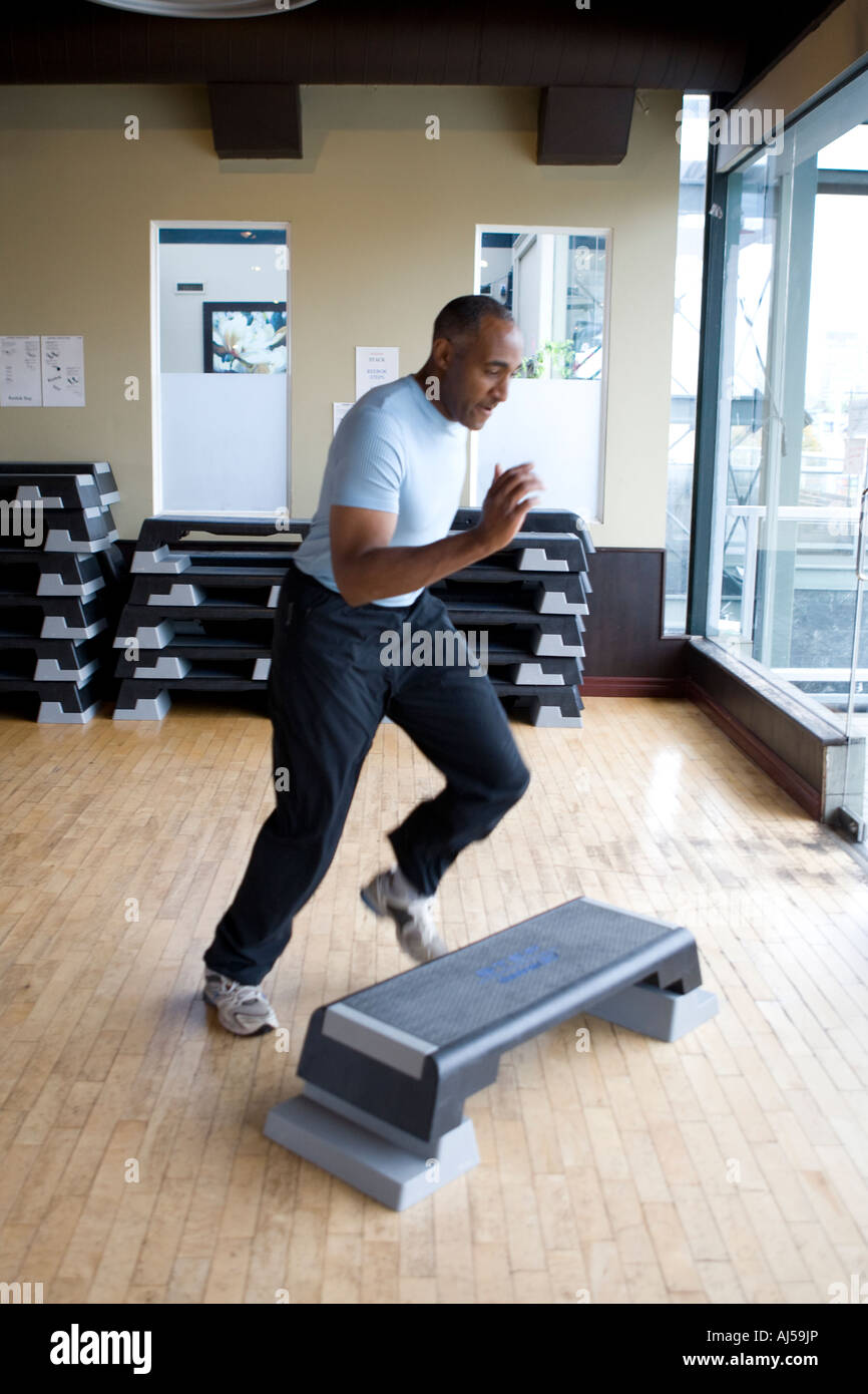 fit fitness male girl exercising in a gym jump step workout Stock Photo -  Alamy