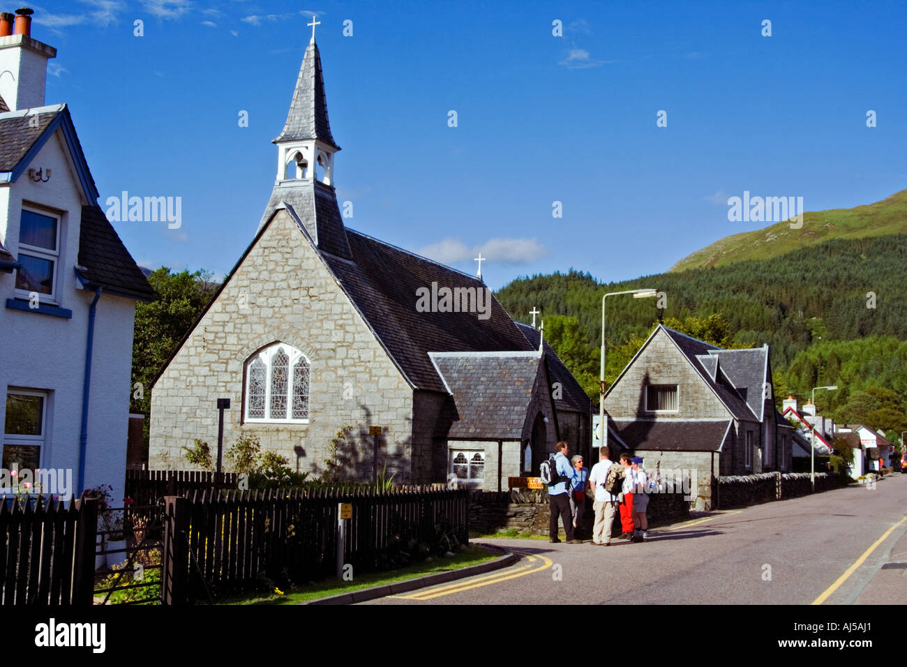 A group of hill walkers talking outside the Glencoe village outdoor centre, Lochaber, Scotland