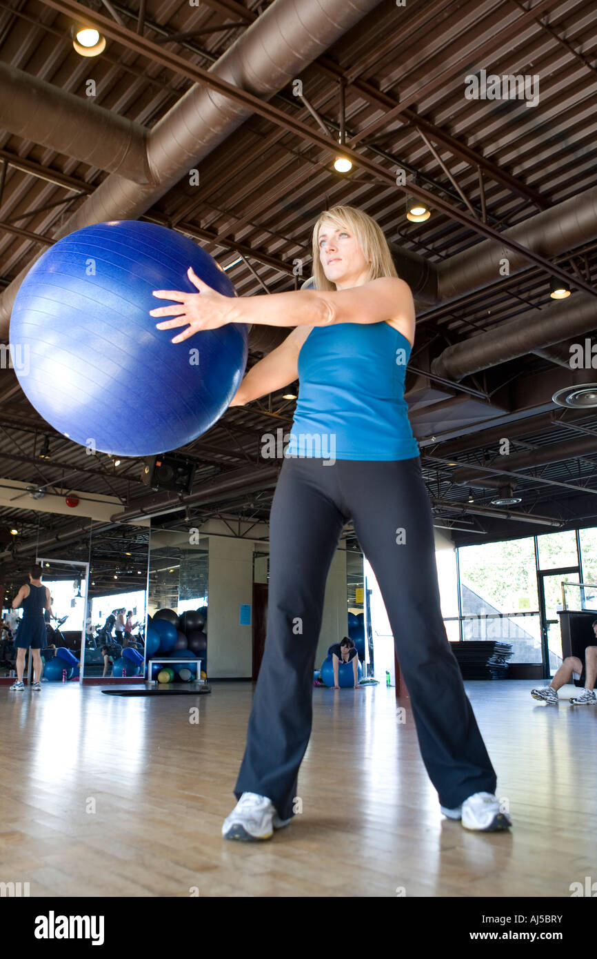 fit fitness female girl exercising in a gym. holding a exercise workout ...