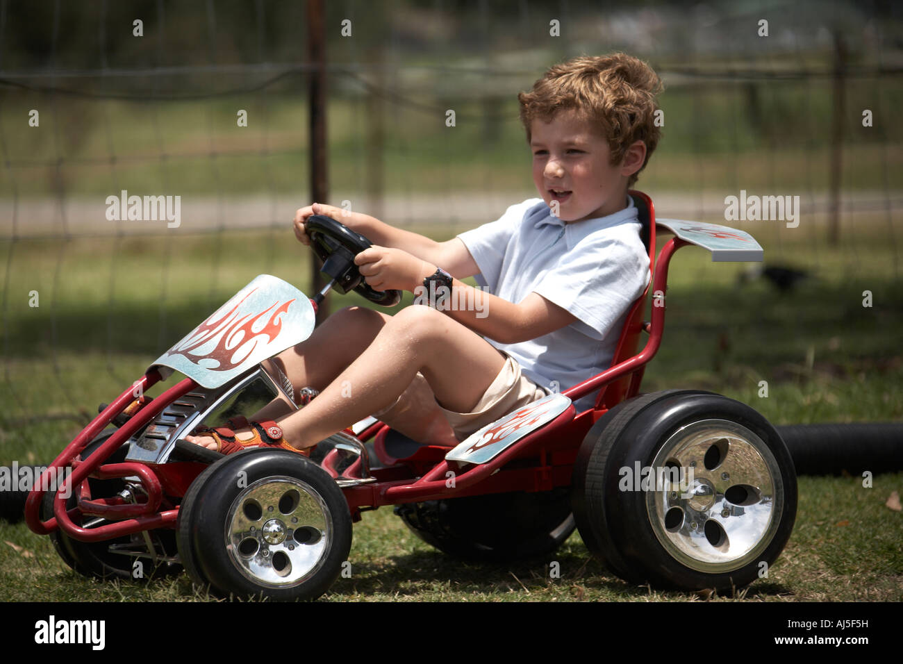 Young boy child driving Go Kart outdoors in Coffs Harbour in New South Wales NSW Australia NAOH Stock Photo