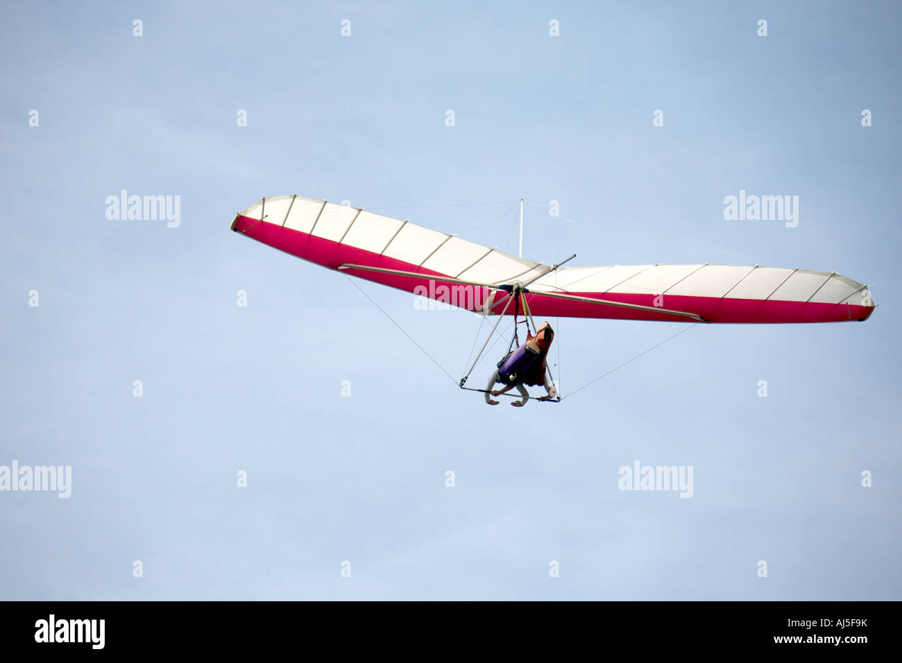Tandem hang glider pilot flying hang gliding with passenger in sky from ridge by sea near Lennox Head in New South Wales NSW Au Stock Photo